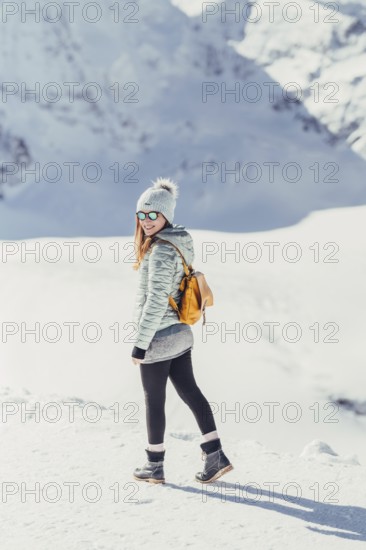 Woman in wintry surroundings in the Engadine in Switzerland