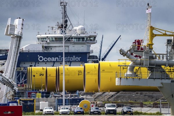 The seaport of Eemshaven, Julianahaven Basin, where the foundation structures, monopiles, for offshore wind farms are stored, which then support the actual wind turbines, the components are transported to the wind farms in the North Sea on large workboats and anchored to the seabed, where the wind turbines are then built, Eemshaven, Netherlands