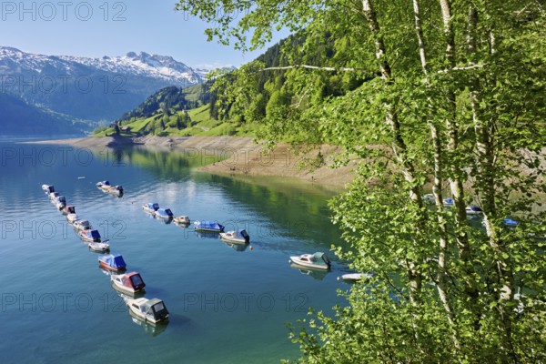 Motorboats moored at the reservoir, snow-covered Alps in the background, Lake Wägital, Canton Schwyz, Switzerland