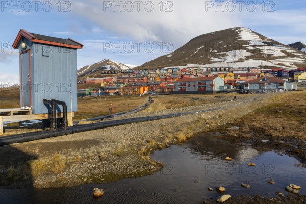 Colourful houses with exposed supply lines, Longyearbyen, Spitsbergen, Svalbard