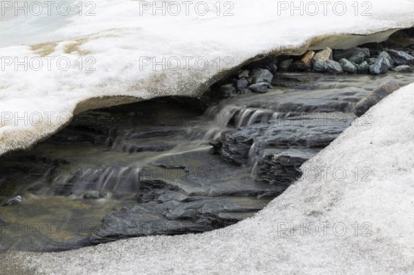 Melting glacier, stones, water, Cooper Camp, Spitsbergen, Svalbard