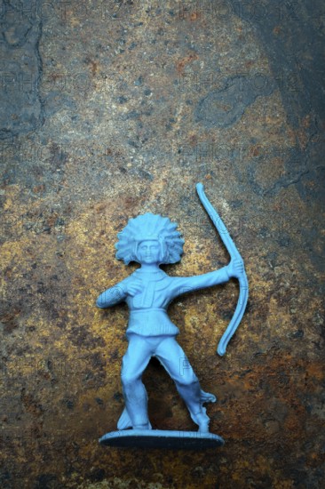 A vibrant blue plastic toy archer stands confidently, showcasing its detailed representation of an Indian Native American figure