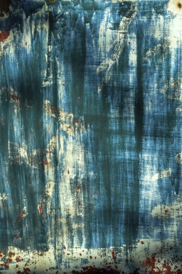 The surface displays an interplay of blue and white hues, layered textures, and hints of rust, creating an intriguing visual experience