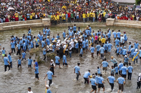 People from the Pnar community perform rituals as they using a tree to celebrate an event organised to mark the Behdienkhlam festival in Jowai, India on July 14, 2025. Behdienkhlam is a vibrant annual festival celebrated by the Pnar (Jaintia) community of Meghalaya, especially in Jowai, to drive away plague and diseases and to pray for a good harvest. Observed in July after the sowing season, it features traditional rituals, offerings to ancestral spirits, and the grand procession of beautifully decorated bamboo structures called rots, which are later immersed in a sacred muddy pool known as Ka Aitnar
