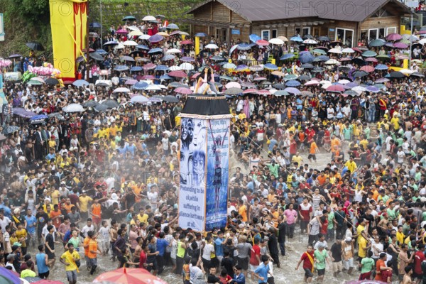 People from the Pnar community move around a Rot themed stop women harrasment as they celebrate an event organised to mark the Behdienkhlam festival in Jowai, India on July 14, 2025. Behdienkhlam is a vibrant annual festival celebrated by the Pnar (Jaintia) community of Meghalaya, especially in Jowai, to drive away plague and diseases and to pray for a good harvest. Observed in July after the sowing season, it features traditional rituals, offerings to ancestral spirits, and the grand procession of beautifully decorated bamboo structures called rots, which are later immersed in a sacred muddy pool known as Ka Aitnar