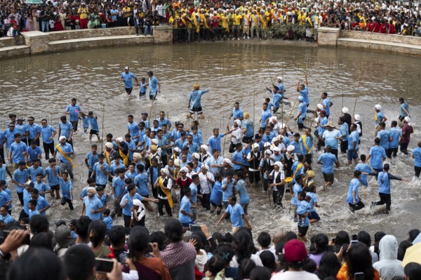 JOWAI, INDIA - JULY 14: People from the Pnar community march in a circle as they celebrate an event organized to mark the Behdienkhlam festival in Jowai, India on July 14, 2025. Behdienkhlam is a vibrant annual festival celebrated by the Pnar (Jaintia) community of Meghalaya, especially in Jowai, to drive away plague and diseases and to pray for a good harvest. Observed in July after the sowing season, it features traditional rituals, offerings to ancestral spirits, and the grand procession of beautifully decorated bamboo structures called rots, which are later immersed in a sacred muddy pool known as Ka Aitnar