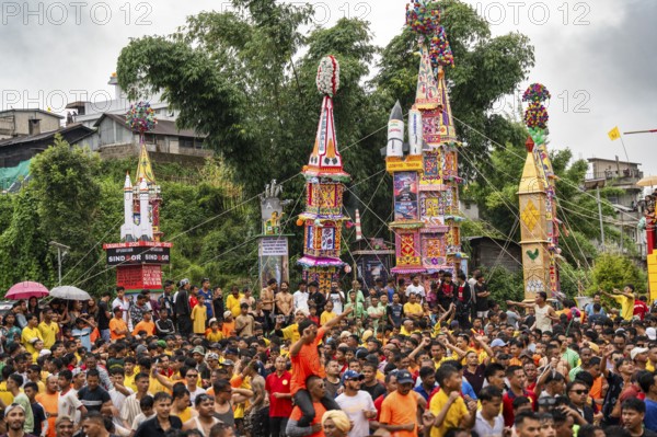 JOWAI, INDIA - JULY 14: People from the Pnar community march in a circle around a Rot as they celebrate an event organised to mark the Behdienkhlam festival in Jowai, India on July 14, 2025. Behdienkhlam is a vibrant annual festival celebrated by the Pnar (Jaintia) community of Meghalaya, especially in Jowai, to drive away plague and diseases and to pray for a good harvest. Observed in July after the sowing season, it features traditional rituals, offerings to ancestral spirits, and the grand procession of beautifully decorated bamboo structures called rots, which are later immersed in a sacred muddy pool known as Ka Aitnar