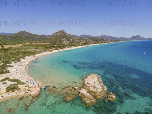 White sandy beaches and turquoise-blue sea stretch for several kilometres on the Costa Rei, a stretch of coastline on the Italian Mediterranean island of Sardinia, making the area one of the most popular holiday destinations in Europe. (Aerial view with a drone), Monte Nai, Costa Rei, Sardinia, Italy