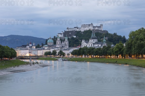 The city of Salzburg with the Salzach shines in the first light of summer morning