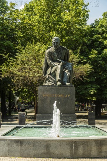 Monument to the Slovakian poet Pavol Országh Hviezdoslav on Hviezdoslav Square, promenade with trees, benches and cafés in Bratislava, Slovakia