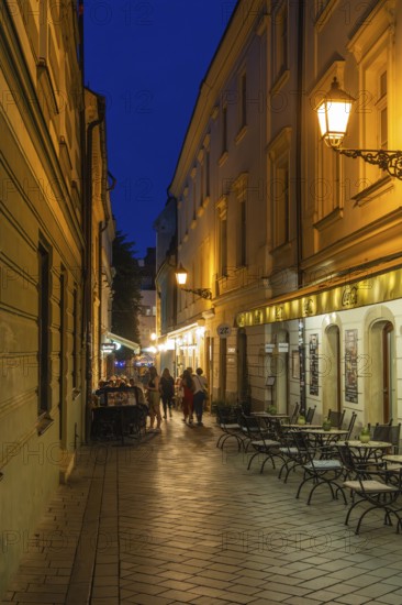 Cosy alley in the old town with illuminated cafés in Bratislava, Slovakia