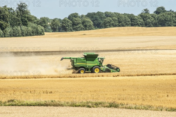 Landscape with threshing of grain with combine harvester at Ystad, Skåne county, Sweden, Scandinavia