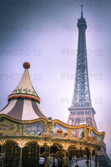 A vintage carousel spins joyfully in a park, with the Eiffel Tower towering majestically in the background. Visitors enjoy a delightful day in scenic Paris, surrounded by beauty. France