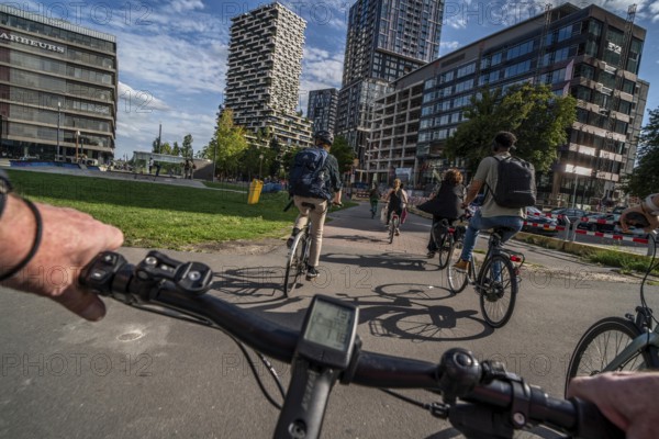 Cycle along the Jaarbeursplein, south of Utrecht Central, HBF, on the central cycle path in the city centre of Utrecht, lanes for pedestrians, cyclists and vehicles are separated, heavy cycle traffic, Netherlands