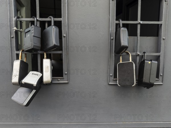 Key boxes on a grille of a basement window for flat flats in the city centre of Bratislava, Slovakia
