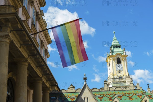 Rainbow flag on the Primatial Palace, in the background is the Old Town Hall of Bratislava, Slovakia