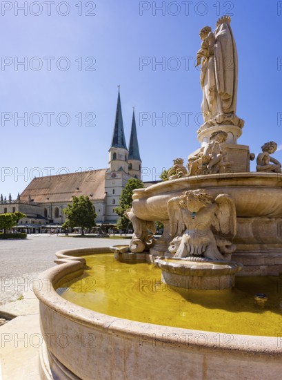 Marienbrunnen fountain on Kapellplatz with St.Philippus and Jakobus collegiate parish church, place of pilgrimage, Altötting, Upper Bavaria, Bavaria, Germany