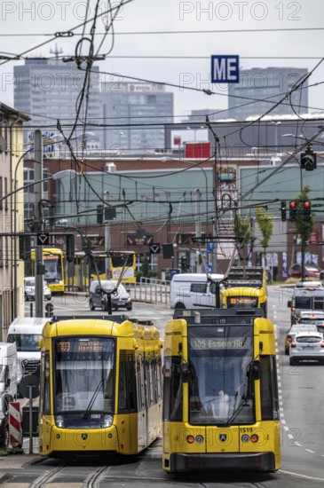 Ruhrbahn tram, on Altendorfer Straße, intersection Helenenstraße, in Essen-Altendorf, rush hour, traffic, skyline of the city centre of Essen, North Rhine-Westphalia, Germany
