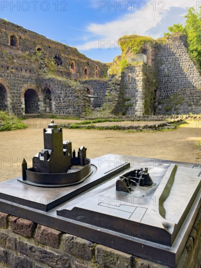 In front left small metal model of the original fortress building of the imperial palace of Emperor Frederick I Barbarossa, built in the Middle Ages around 1184 on today's banks of the Rhine, right next to it for direct comparison model of today's ruin, in the background part of ruin, Kaiserswerth, Düsseldorf, North Rhine-Westphalia, Germany