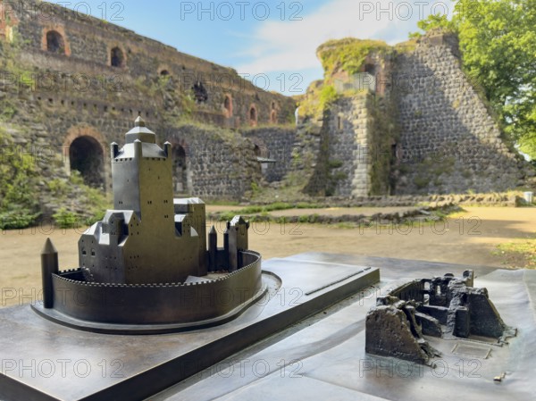In front left small metal model of the original fortress building of the imperial palace of Emperor Frederick I Barbarossa, built in the Middle Ages around 1184 on today's banks of the Rhine, right next to it for direct comparison model of today's ruin, in the background part of ruin, Kaiserswerth, Düsseldorf, North Rhine-Westphalia, Germany