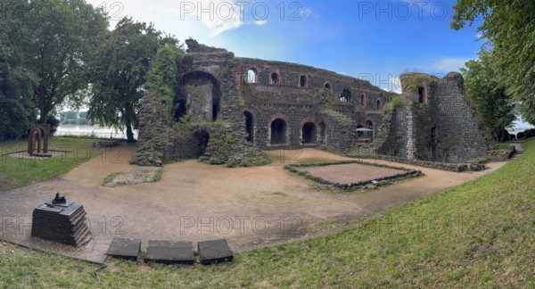 Panoramic photo of the ruins of the imperial palace of Emperor Frederick I Barbarossa, built in the Middle Ages around 1184 on the left in the background of today's banks of the Rhine, in the foreground small model of the original fortress building, Kaiserswerth, Düsseldorf, North Rhine-Westphalia, Germany