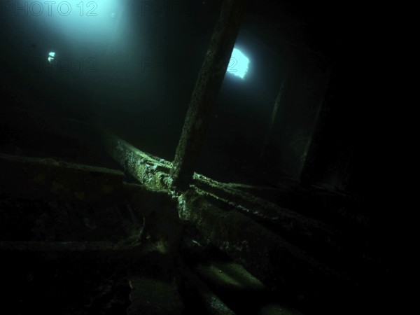 A mysterious, dark room in the shipwreck with blue light and shadows. Dive site wreck of the Cimentière, Giens peninsula, Mediterranean, Provence Alpes Côte d'Azur, France