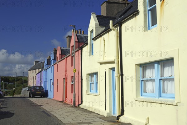 Brightly coloured house facade in sunny weather along a quiet street, Scalloway, Shetland Islands, Scotland, United Kingdom