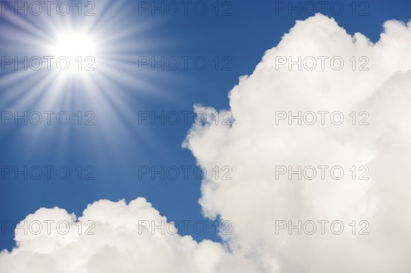 Symbolic image, global warming, heat, a bright sunshine next to fluffy white clouds in a clear blue sky, Baden-Württemberg, Germany