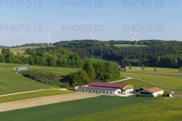 Idyllic rural scene with windmills, green fields and a farm under a blue sky, near Westerheim, Swabian Alb, Baden-Württemberg, Germany
