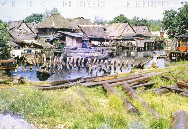 Attap houses of fishing village on stilts, Singapore, southeast Asia c 1963