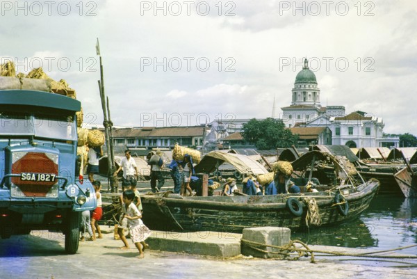 Unloading cargo boat onto lorry, Singapore River, Singapore, southeast Asia c 1963