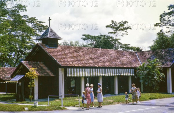European women and children outside Christian chapel or church, from a series about Singapore and Johor Bahru, Malaysia south east Asia c 1963 location unknown possibly a garrison settlement