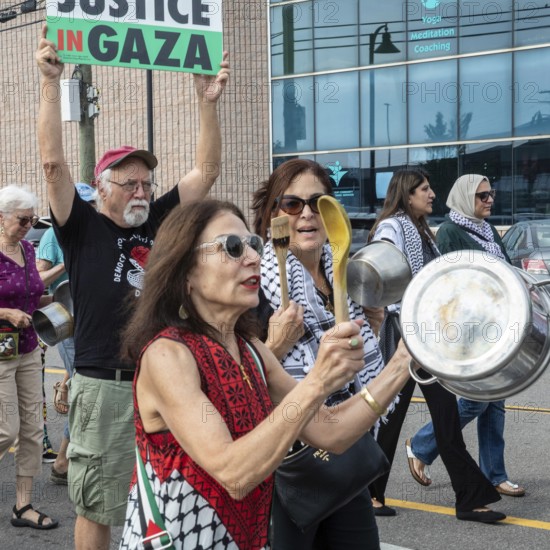 Detroit, Michigan USA - 26 July 2025 - Protesters rally at Eastern Market, banging empty pots to protest starvation in Gaza
