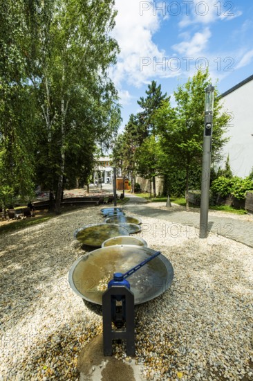 Small park with seating, a playground and a fountain at the entrance to Trencin Castle, Capital of Culture 2026, Trencín, Slovakia