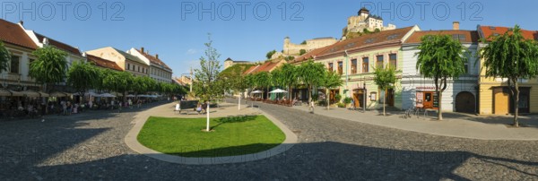 Peace Square with cafés in the old town centre of Trencin, Trencin Castle in the background, Capital of Culture 2026, Trencín, Slovakia