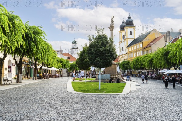 Peace Square with cafés in the old town of Trencin, in the background the Piarist Church of St Francis Xavier, Capital of Culture 2026, Trencín, Slovakia
