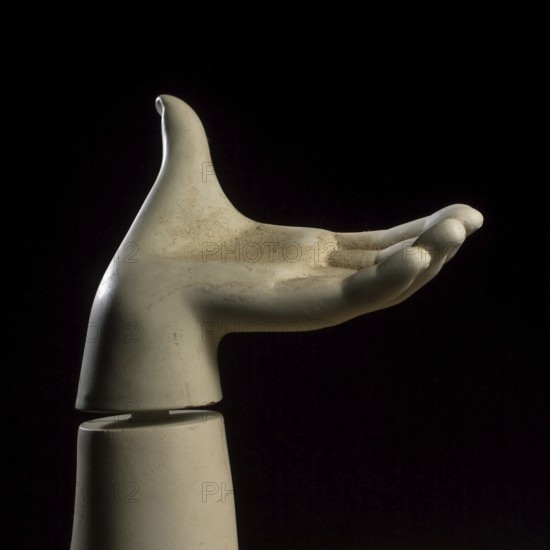 A detailed view of a mannequin hand with fingers slightly curled, creating a graceful pose against a dark background, showcasing the artistry in design and craftsmanship