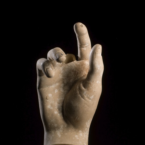 A sculpted hand gesture captures attention with its realistic depiction. The focus is on the fingers, showcasing intricate details and textures against a contrasting dark backdrop