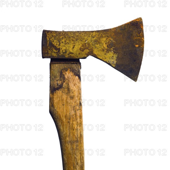 A rusty axel stands prominently against a simple backdrop, showcasing its worn texture and distinctive features. The sunlight enhances its patina, revealing years of use and history