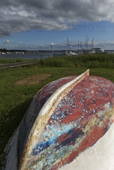Boat with keel up, weathered paint in many colours, Jachthafen Baltic resort Rerik, Mecklenburg-Vorpommern, Germany