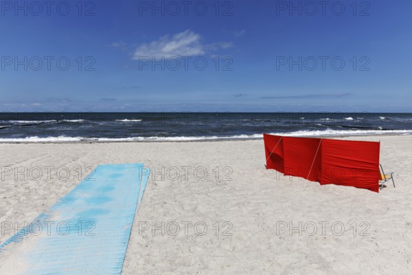 Deserted beach with red windbreak and blue sand mat for barrier-free beach access, blue sky, Baltic Sea near Kühlungsborn, Mecklenburg-Western Pomerania, Germany