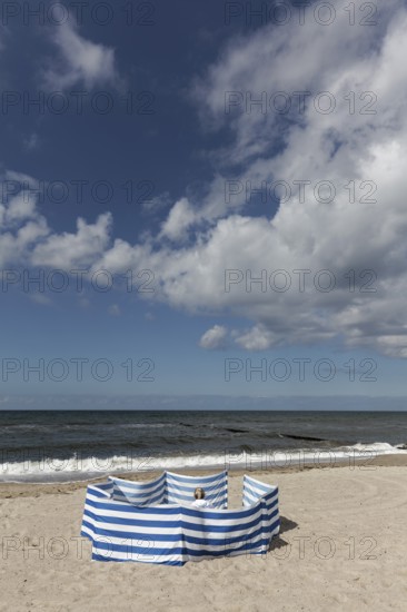 Deserted beach with person behind windbreak, blue sky, Baltic Sea near Kühlungsborn, Mecklenburg-Western Pomerania, Germany
