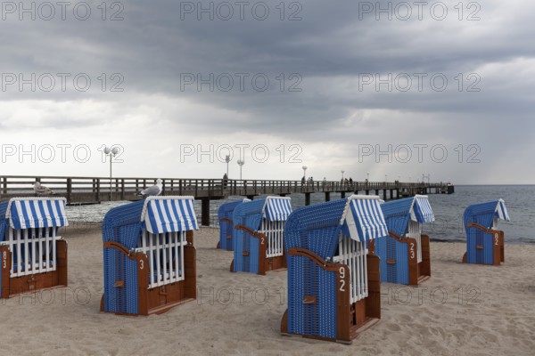 Pier and beach with closed beach chairs, rain clouds, Kühlungsborn, Baltic Sea, Mecklenburg-Western Pomerania, Germany