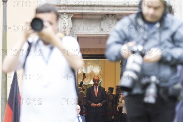 Friedrich Merz (CDU, German Chancellor) waits behind photographers for Emmanuel Macron (President of the French Republic) in front of a joint meeting at Villa Borsig in Berlin on 23 July 2025