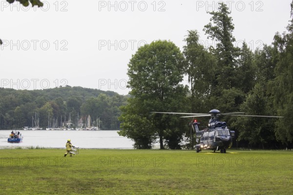 A firefighter transports a ladder to a helicopter in front of a joint meeting between Friedrich Merz (CDU, German Chancellor) and Emmanuel Macron (President of the French Republic) at the Villa Borsig in Berlin on 23 July 2025
