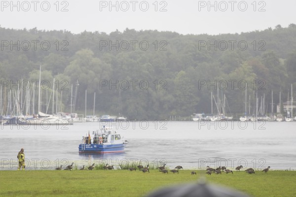 A water police boat guards the shore of Villa Borsig in front of a joint meeting between Friedrich Merz (CDU, German Chancellor) and Emmanuel Macron (President of the French Republic) at Villa Borsig in Berlin on 23 July 2025