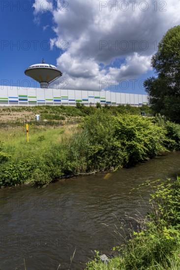 The river Dhünn, 40 km long river, which flows into the Wupper near Leverkusen, renaturalised section, here shortly in front of the mouth along the A1 motorway, at the Leverkusen-West junction, noise barrier, landmark water tower Leverkusen, North Rhine-Westphalia, Germany