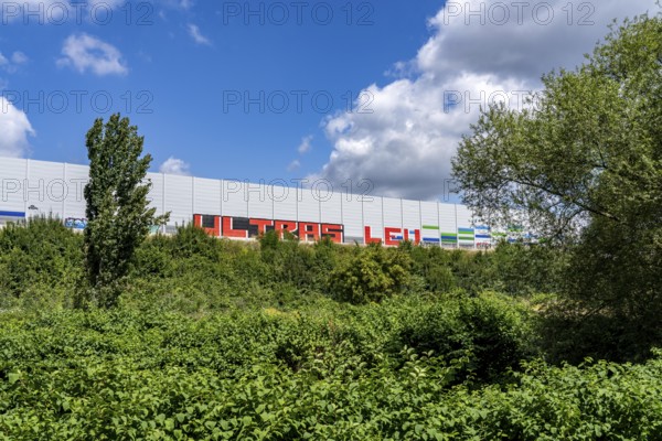 Green corridor with the river Dhünn, 40 km long river that flows into the Wupper near Leverkusen, renaturalised section, here shortly in front of the mouth along the A1 motorway, at the Leverkusen-West junction, noise barrier, graffiti by the Ultras Leverkusen, North Rhine-Westphalia, Germany