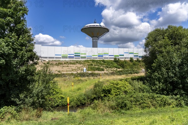 The river Dhünn, 40 km long river, which flows into the Wupper near Leverkusen, renaturalised section, here shortly in front of the mouth along the A1 motorway, at the Leverkusen-West junction, noise barrier, landmark water tower Leverkusen, North Rhine-Westphalia, Germany