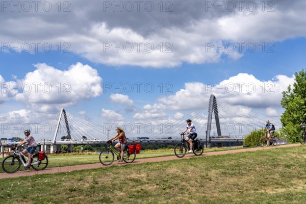 Cycle path in the Neulandpark in Leverkusen on the Rhine, in the background the new Rhine bridge of the A1, 1 construction phase, near Leverkusen, participants of the North Rhine-Westphalia Cycle Tour, 4-day, 220 KM long round trip through the Rhineland, with over 1400 participants, North Rhine-Westphalia, Germany
